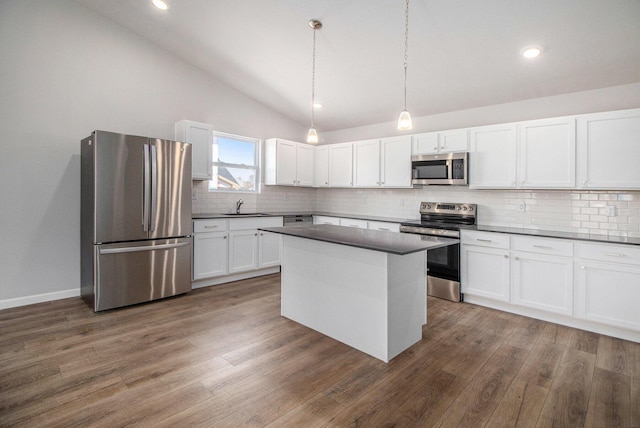 8775 E Sturtevant Ave, Richland, MI 49083 - kitchen with appliances with stainless steel finishes, a sink, lofted ceiling, dark countertops, and decorative backsplash