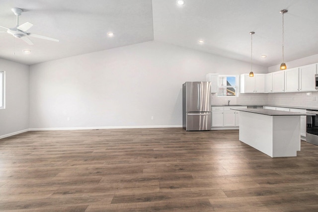 8775 E Sturtevant Ave, Richland, MI 49083 - kitchen featuring appliances with stainless steel finishes, vaulted ceiling, a sink, a center island, and a ceiling fan