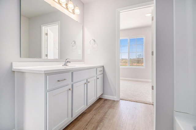 8775 E Sturtevant Ave, Richland, MI 49083 - full bathroom with wood finished floors, vanity, and baseboards
