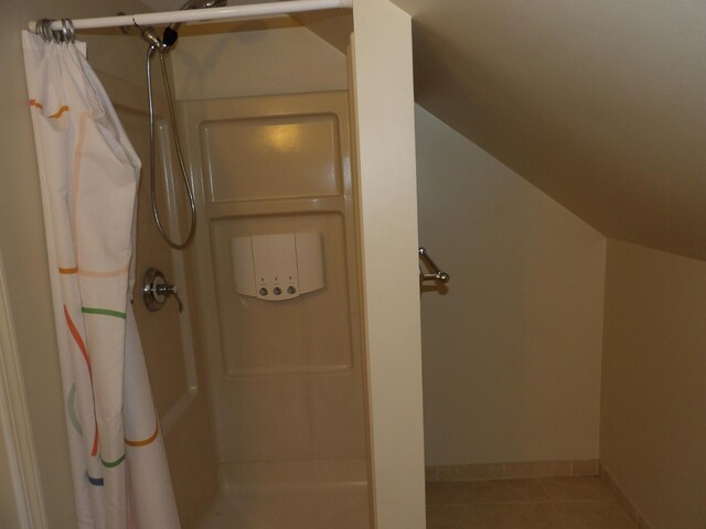 7335 Colony Dr, West Bloomfield, MI 48323 - bathroom featuring a shower with shower curtain and tile patterned floors
