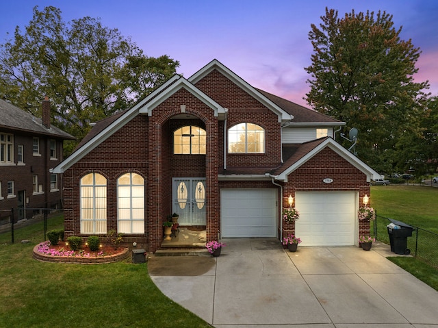 view of front of house featuring a garage and a yard