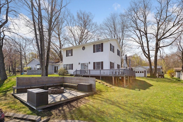 9050 Virginia Ave, Mecosta, MI 49332 - rear view of property featuring a wooden deck, a yard, and a fire pit