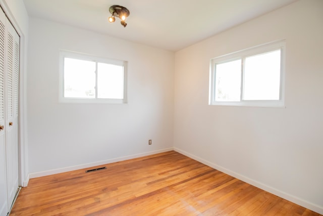 spare room with plenty of natural light and light wood-type flooring