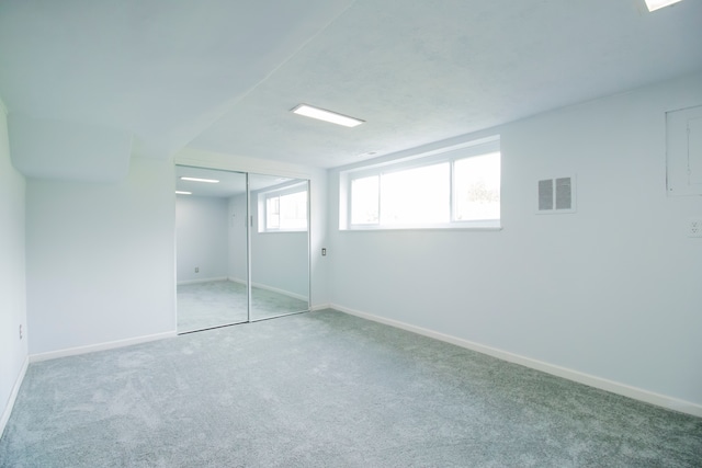 unfurnished bedroom featuring light colored carpet and a closet