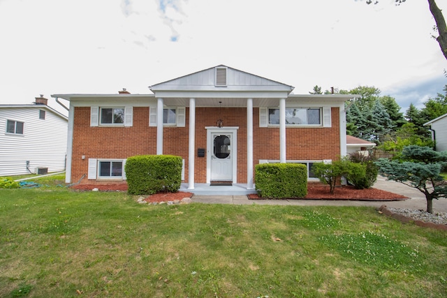 view of front of property featuring a front yard and central AC unit