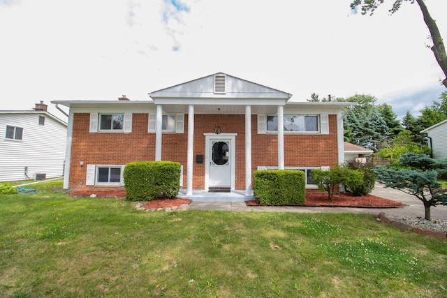 view of front of house with a front yard and cooling unit