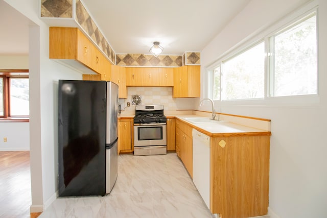 kitchen featuring decorative backsplash, sink, plenty of natural light, and appliances with stainless steel finishes