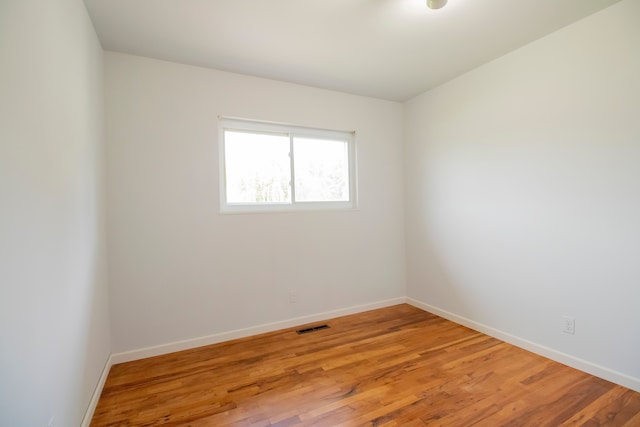 spare room with light hardwood / wood-style flooring