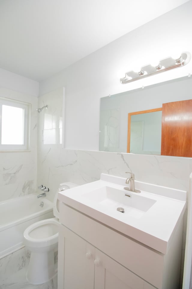 full bathroom featuring vanity, tiled shower / bath combo, and toilet