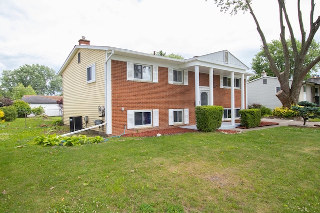 view of front of house with cooling unit and a front yard