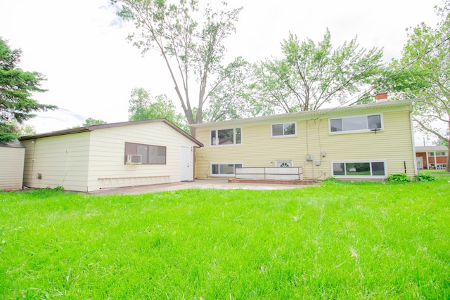 back of property featuring a lawn and a patio