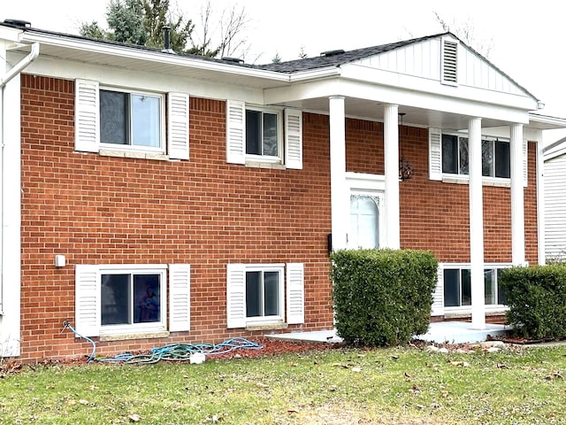 rear view of property with a lawn