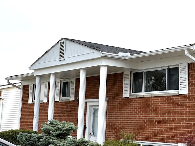 view of side of property featuring covered porch