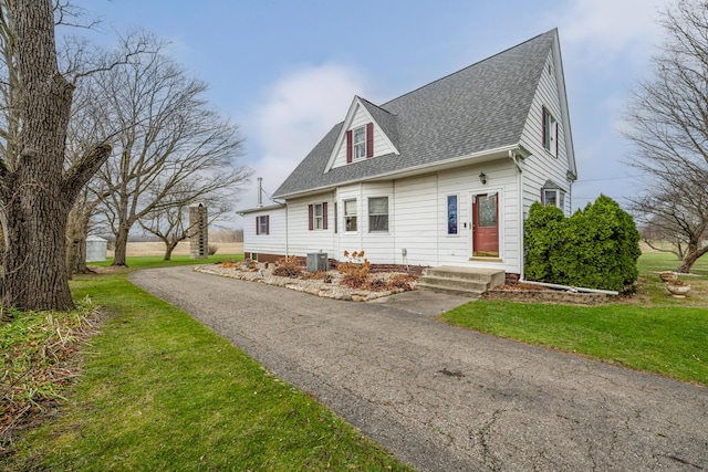 cape cod home with a front lawn