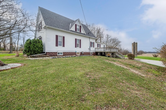 view of front of house with a front yard and a deck