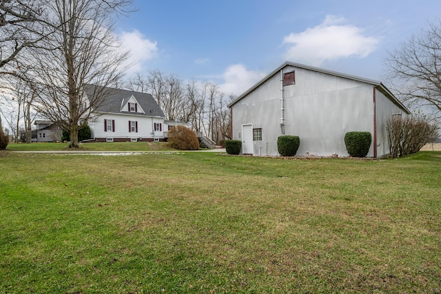 view of home's exterior featuring an outbuilding and a yard