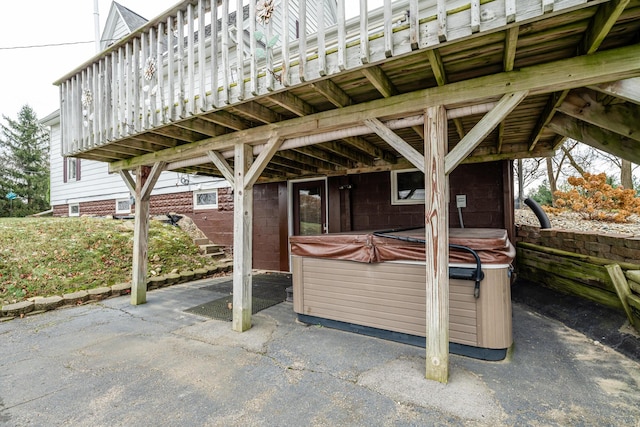 view of patio with a wooden deck and a hot tub