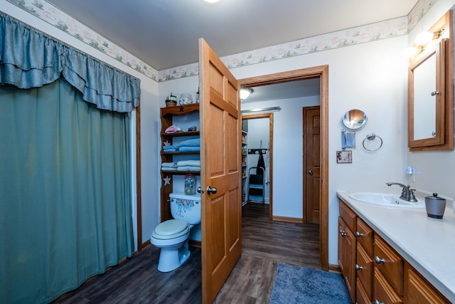 bathroom with hardwood / wood-style flooring, vanity, and toilet