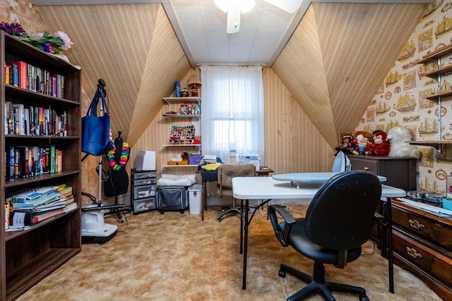 office featuring wooden walls, light colored carpet, and vaulted ceiling