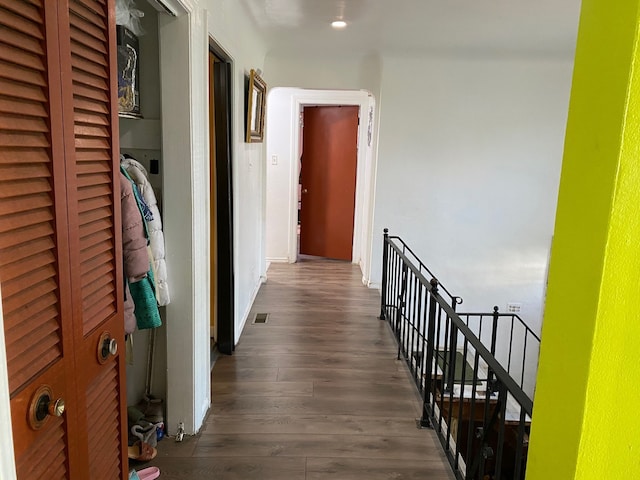 corridor with dark hardwood / wood-style flooring