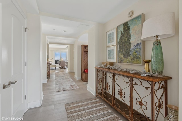 200 Lake St Unit 3B, Saint Joseph, MI 49085 - hallway featuring light wood finished floors and arched walkways