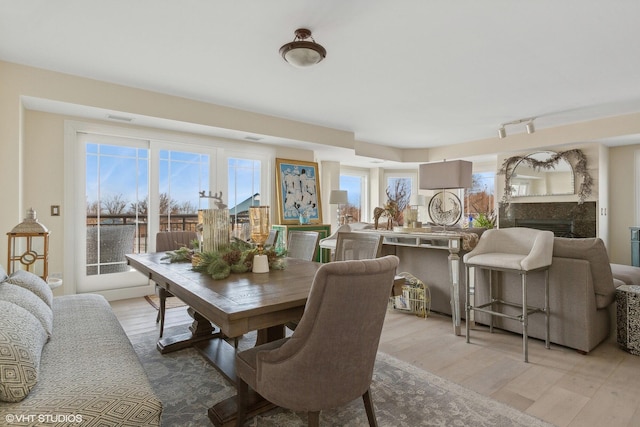 200 Lake St Unit 3B, Saint Joseph, MI 49085 - dining room with light wood-style floors and a fireplace