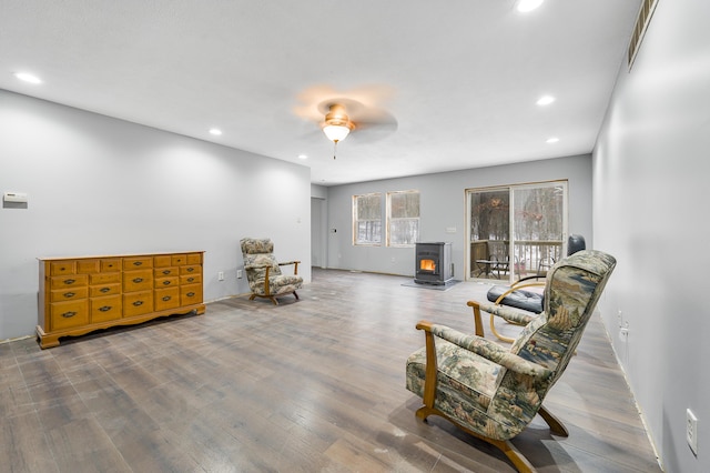 9078 N Ferris Ave, Bitely, MI 49309 - sitting room featuring recessed lighting, wood finished floors, a ceiling fan, and a wood stove