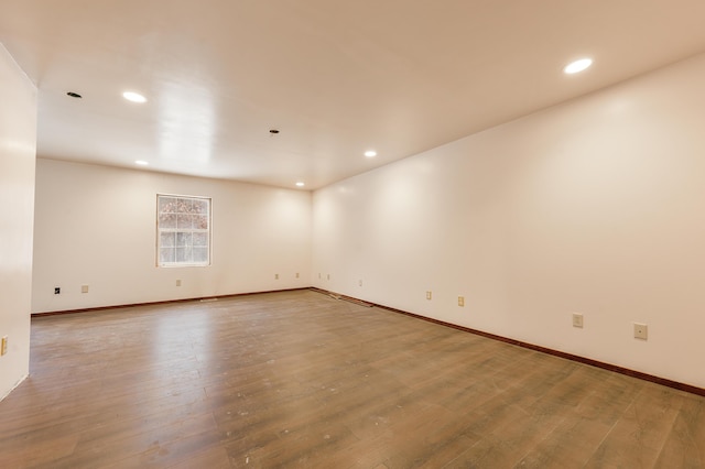 9078 N Ferris Ave, Bitely, MI 49309 - empty room featuring recessed lighting, wood finished floors, and baseboards