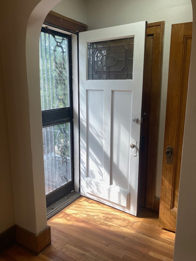 doorway to outside with wood-type flooring