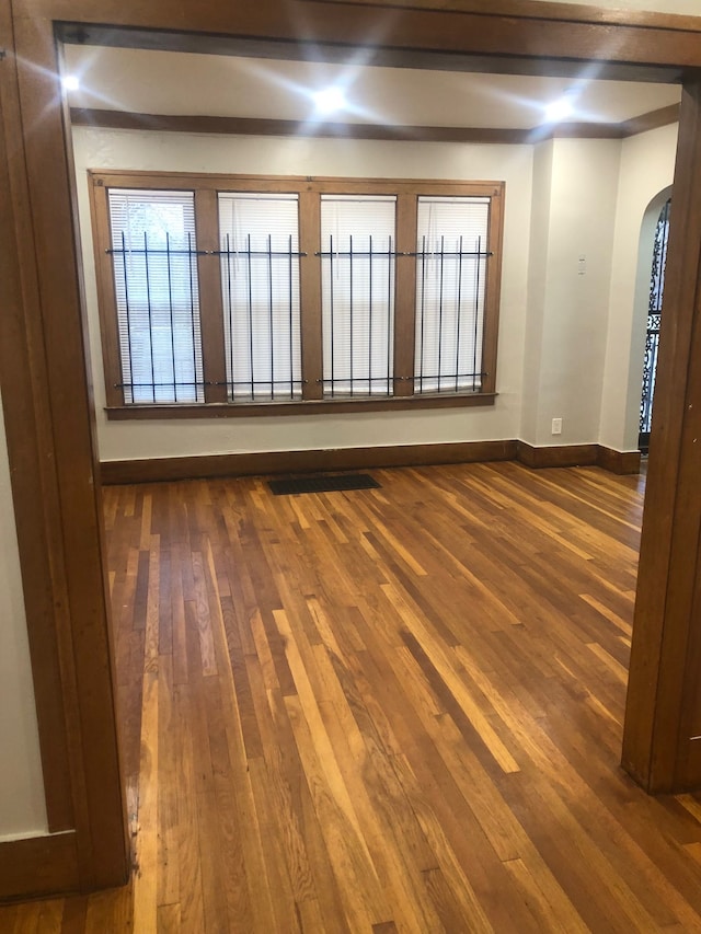 empty room with dark hardwood / wood-style flooring