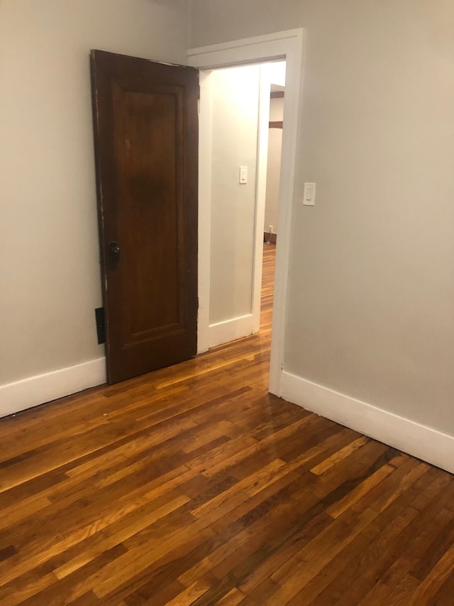 spare room with dark hardwood / wood-style flooring