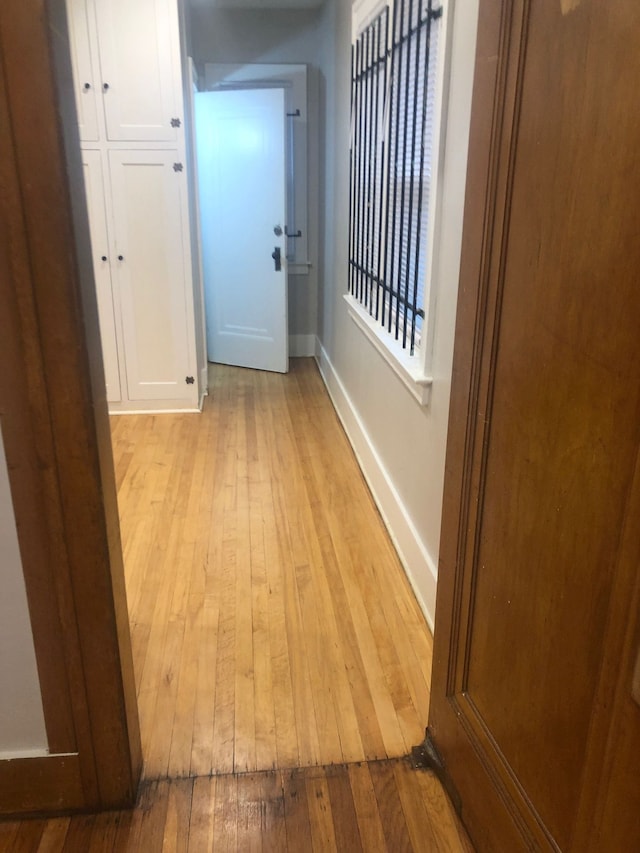 corridor with light hardwood / wood-style flooring