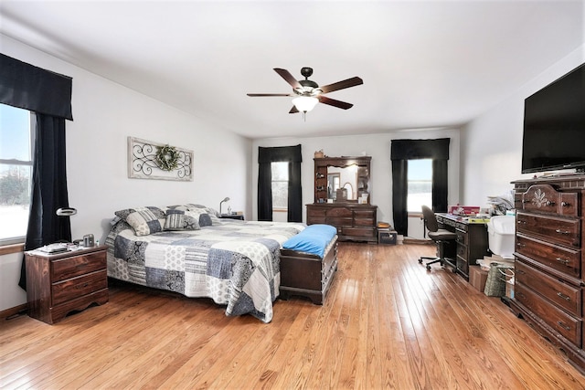 7580 River Rd, Evart, MI 49631 - bedroom featuring multiple windows, light wood-style flooring, ceiling fan, and a desk