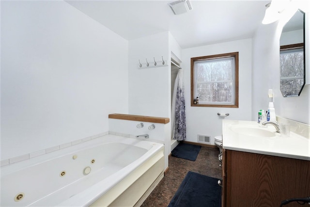 7580 River Rd, Evart, MI 49631 - bathroom with vanity, a whirlpool tub, toilet, and baseboards