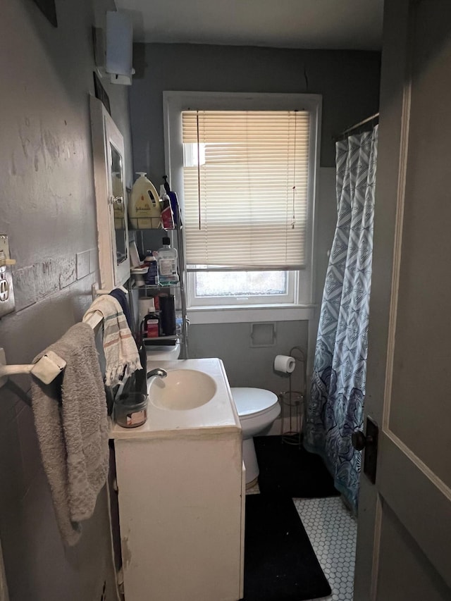 bathroom with vanity, curtained shower, and toilet