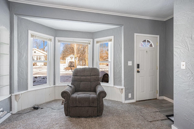 living area featuring hardwood / wood-style floors and ornamental molding