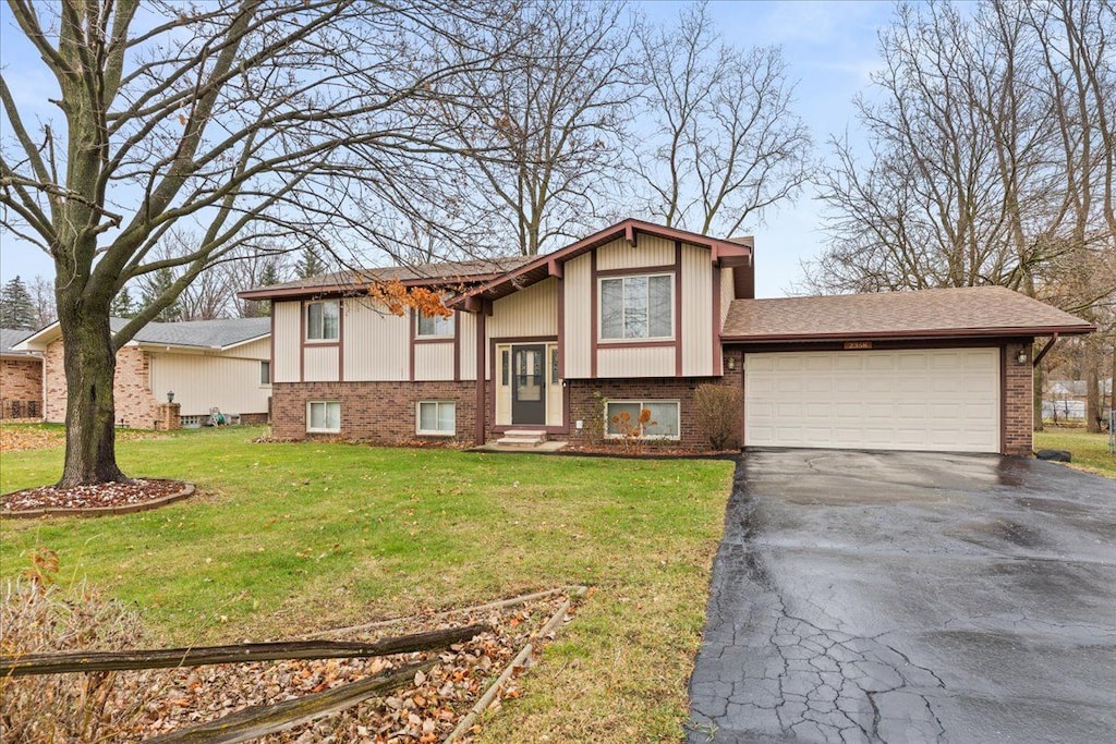 split foyer home with a front yard and a garage