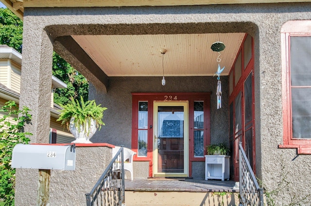 view of exterior entry featuring a porch