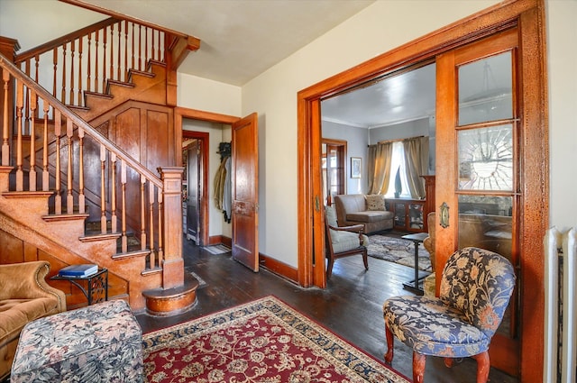 interior space featuring radiator heating unit, dark hardwood / wood-style flooring, and crown molding