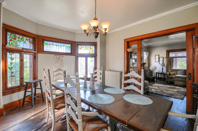 dining area with french doors, crown molding, dark hardwood / wood-style floors, radiator heating unit, and a chandelier