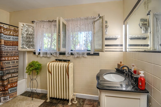 bathroom with shower / bathtub combination, vanity, radiator, and tile walls