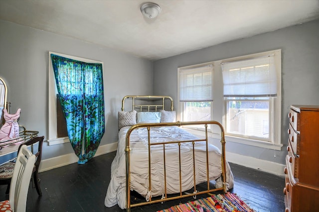 bedroom with dark wood-type flooring