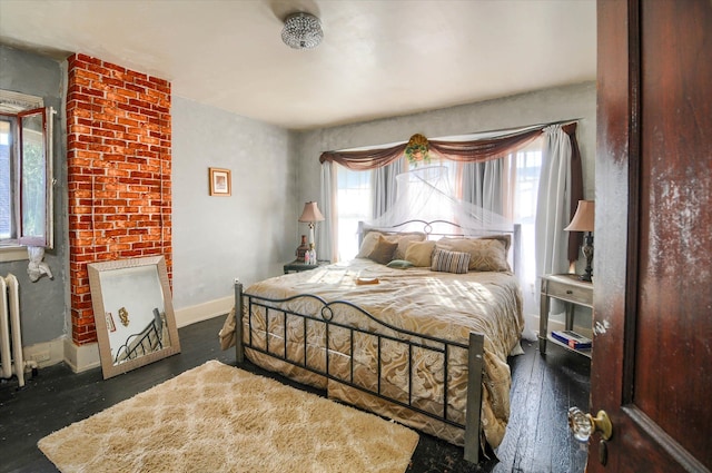 bedroom with radiator and dark wood-type flooring