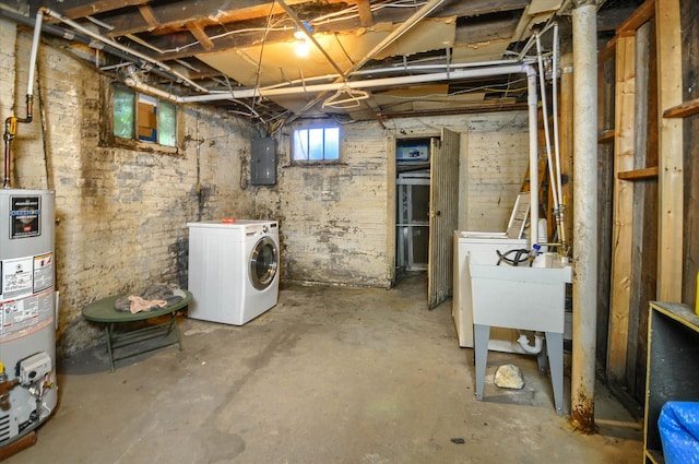 basement featuring electric panel, gas water heater, and independent washer and dryer