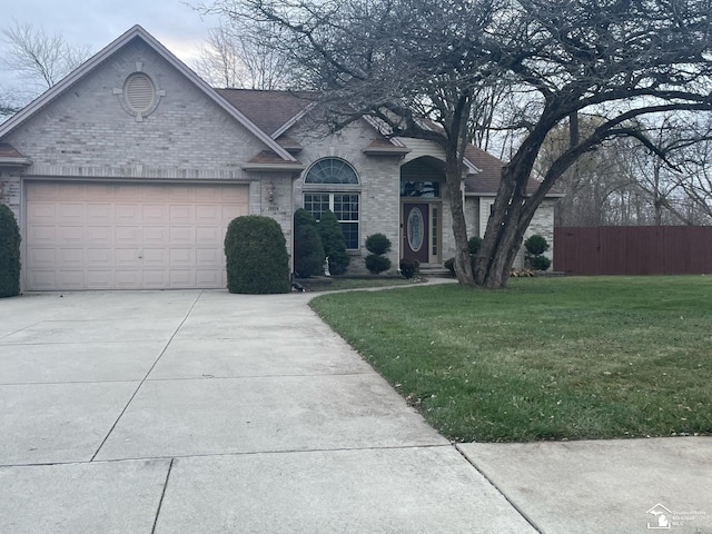 view of front of property with a garage and a front lawn