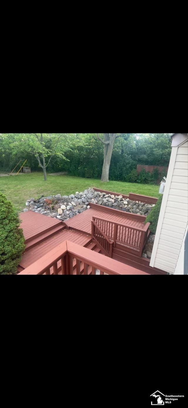 wooden terrace with a lawn