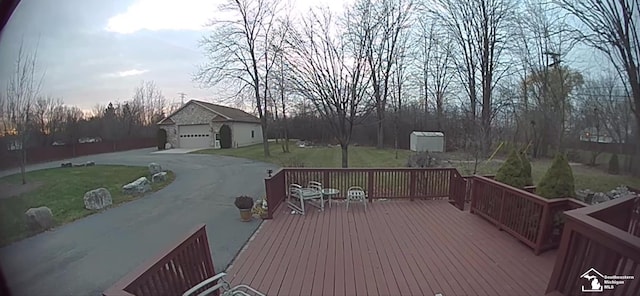 26926 Reaume, Trenton, MI 48183 - wooden deck featuring an outbuilding, a lawn, a garage, and concrete driveway