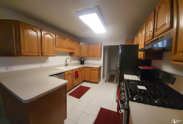 26926 Reaume, Trenton, MI 48183 - kitchen featuring gas range, under cabinet range hood, light tile patterned floors, a peninsula, and light countertops