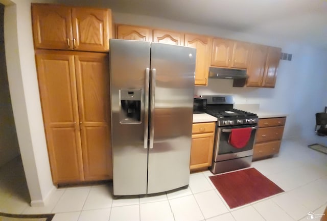 kitchen with appliances with stainless steel finishes and light tile patterned floors