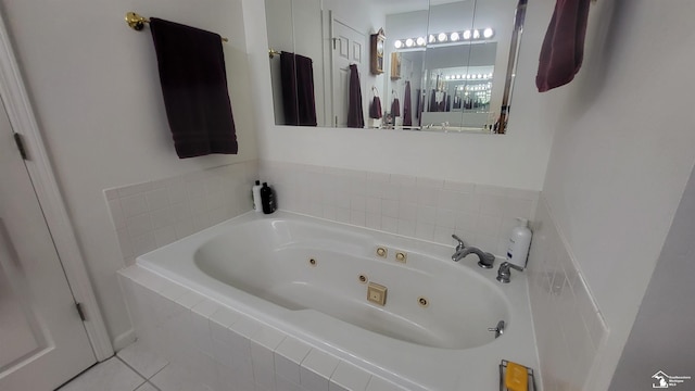 bathroom with tile patterned floors and tiled tub